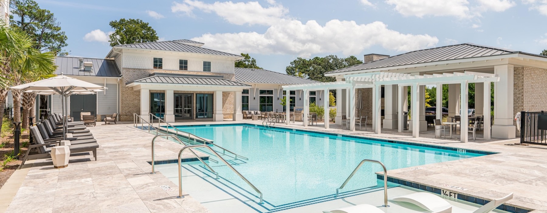 Large sparkling pool with large pool deck and lounge chairs