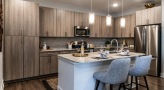 a kitchen with island and ample lighting