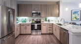 spacious c-shaped kitchen with track lighting