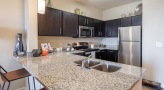 open serving counter with stools in kitchen