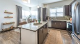 large kitchen with island next to dining area