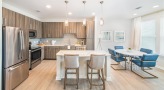 a kitchen with a dining table and chairs