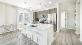 a kitchen with an island and chairs