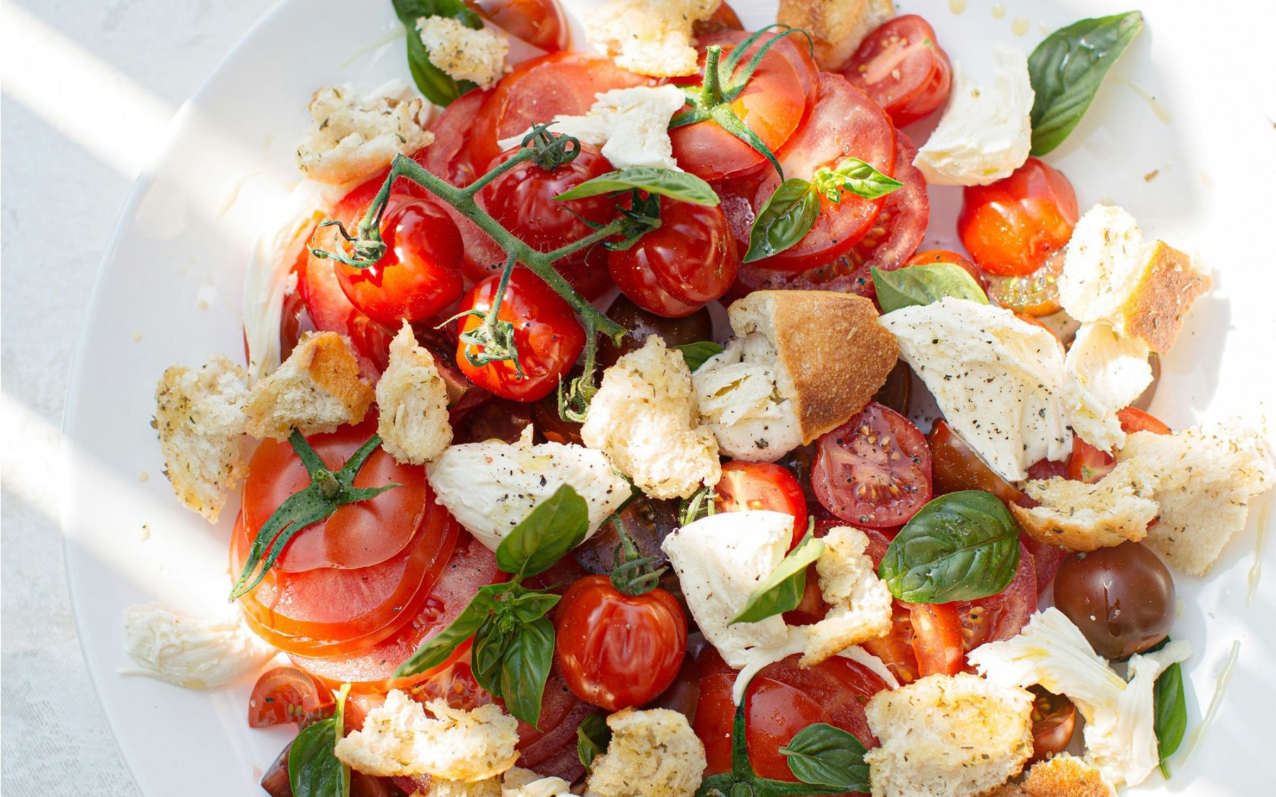 plate of fresh tomato, mozzarella, and basil 