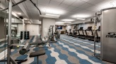 carpeted fitness center with ample lighting