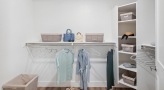 wide walk-in closet with built-in shelving