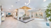 Large well lit lobby with seating and a desk