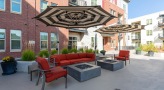 firepits with umbrella shaded couch and chairs