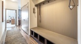 bright hallway entrance with mudroom bench