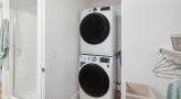 stacked washer/dryer next to bathroom