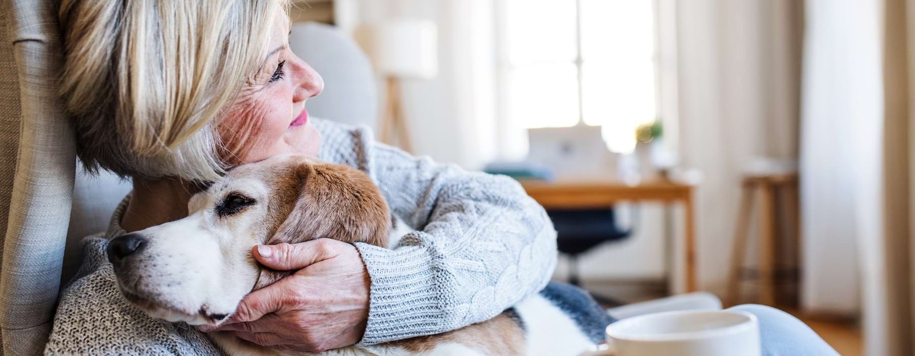 a woman sitting on a couch with her dog
