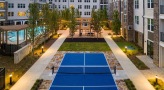 pickleball court in courtyard near pool