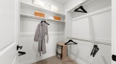 lighted walk-in closet with shelving