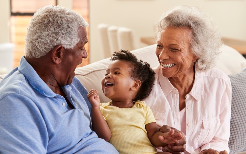 grandparents and a grandchild laughing together