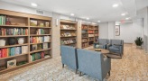 a bright library room with chairs and coffee table