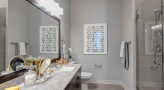 Large well lit bathroom with brown accents 