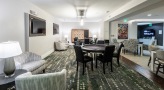 poker tables and large scrabble board on the wall in game room