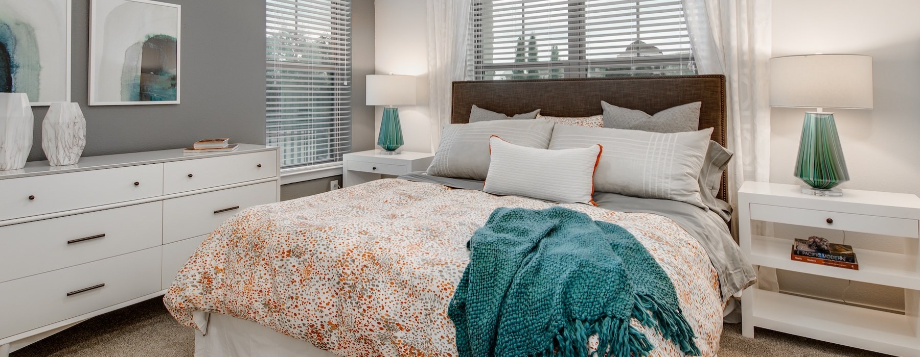 bedroom with nightstands and a large window