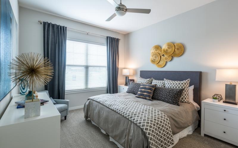 carpeted bedroom with large windows