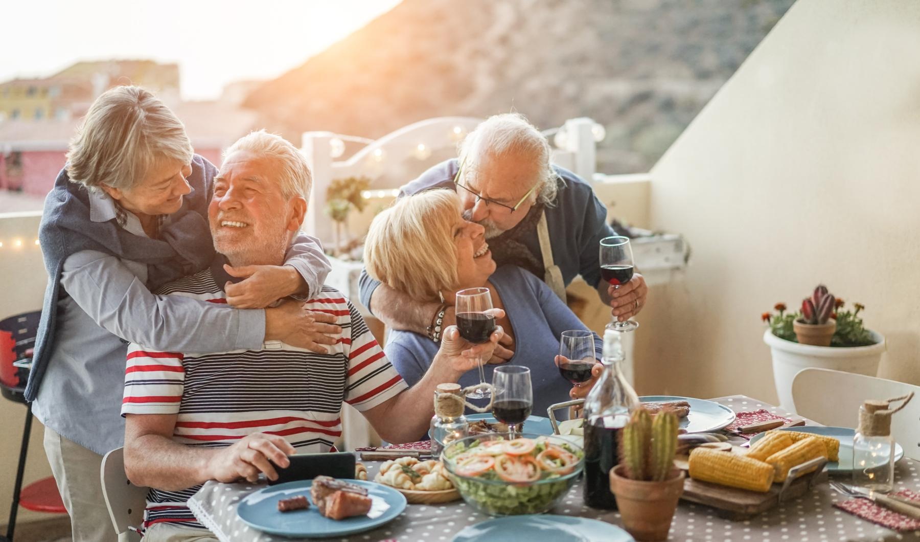 Love where you live a group of people sitting at a table with food and drinks