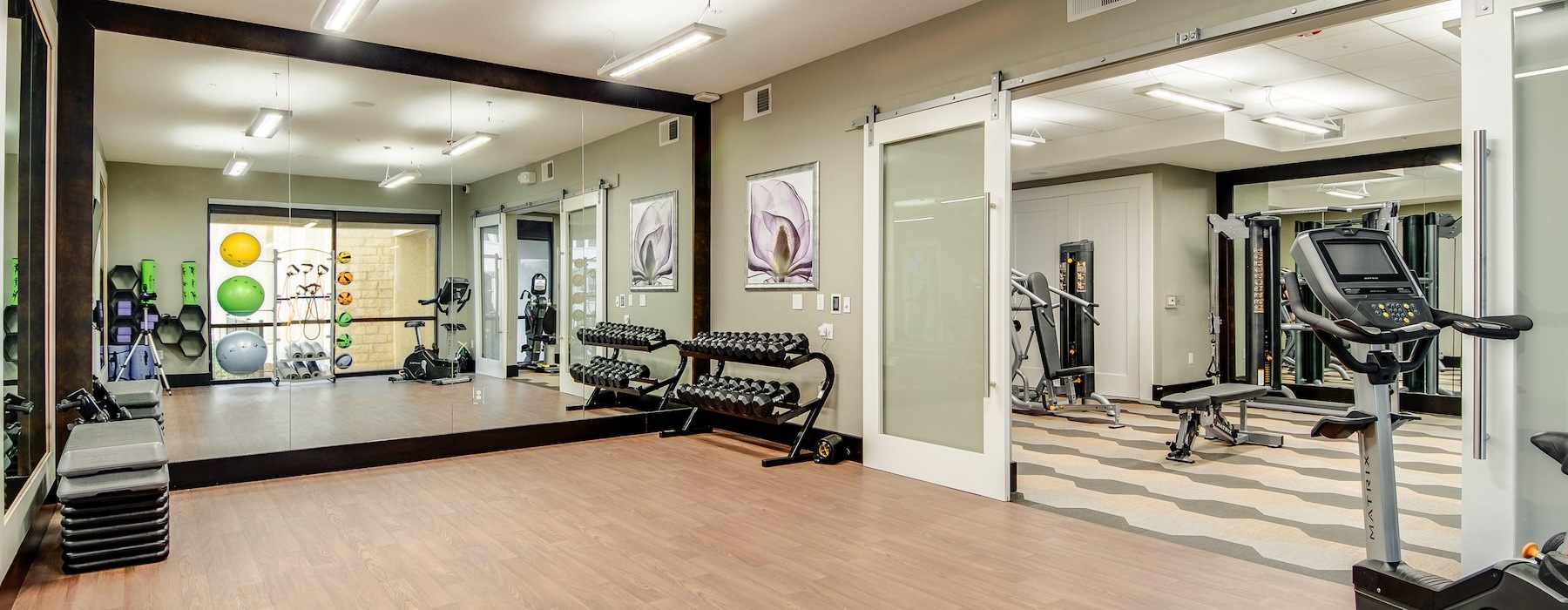 a room with a large mirror and exercise equipment