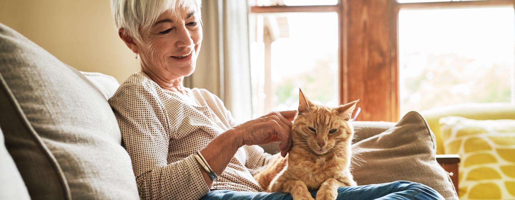 Woman sitting in her living room with her cat