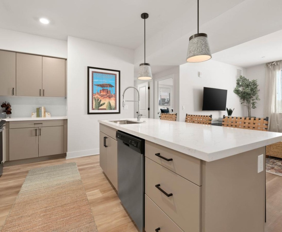 Model kitchen at Destinations Pueblo apartments in Summerlin, NV, featuring wood grain flooring and a kitchen island.