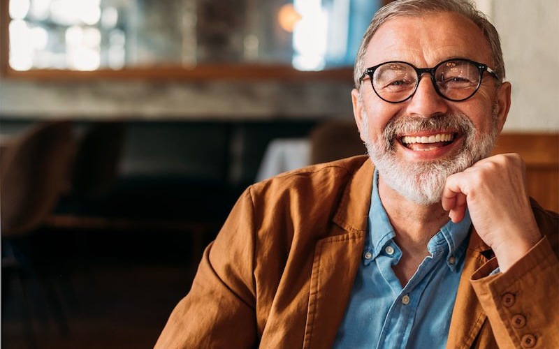 a man sitting at a table smiling