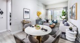 a living room with a large table and chairs