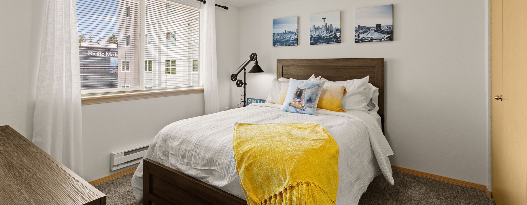 a bedroom with a large window and bed