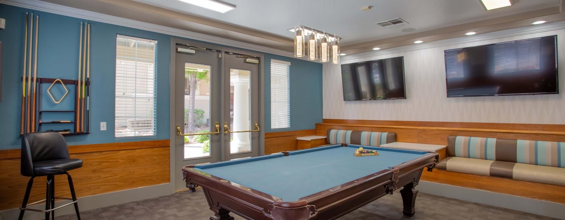 a room with tvs and a pool table