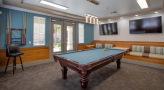a room with a couch and pool tables