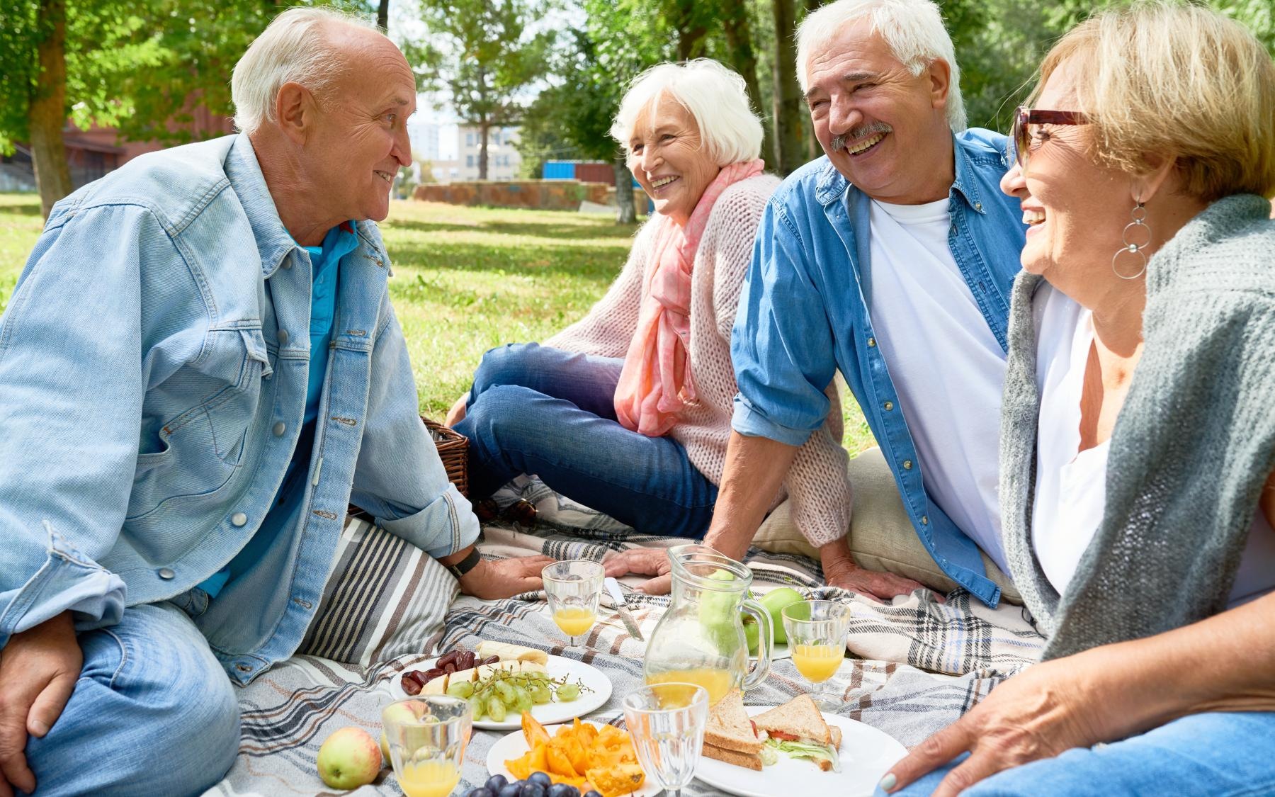 Lifestyle Group of people sitting outside on a blanket