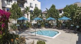 pool area with lounge chairs and trees