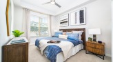 Large bedroom with carpeted floors 