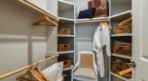 large closet with wood shelving