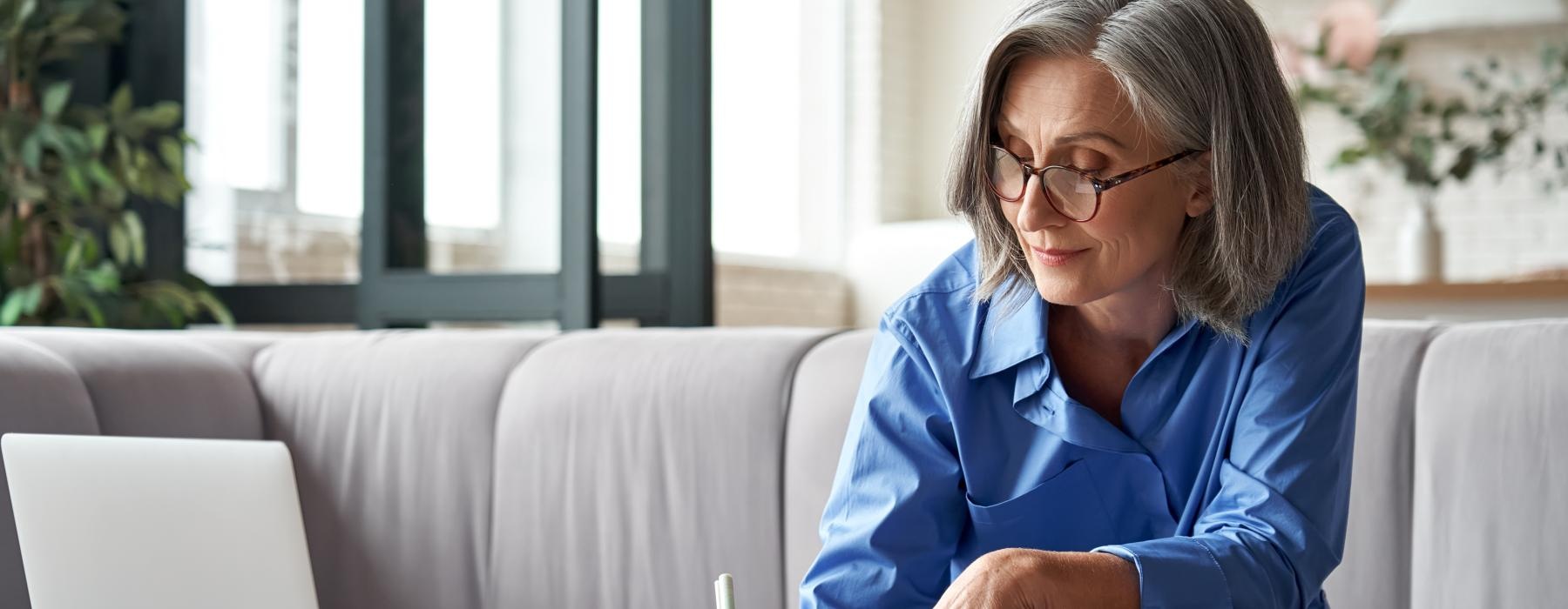 Woman writing while sitting in a well lit room 