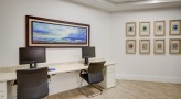 computer work station with a desk and chairs