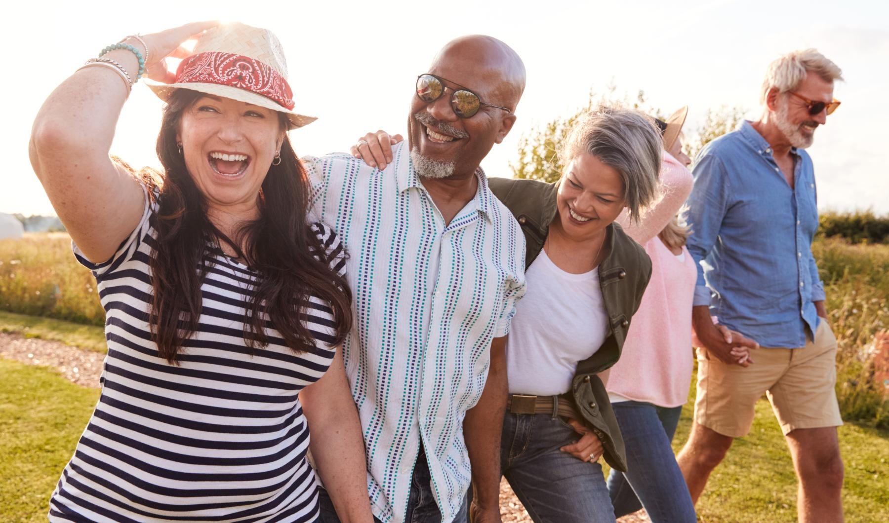 a group of people walking outside and smiling