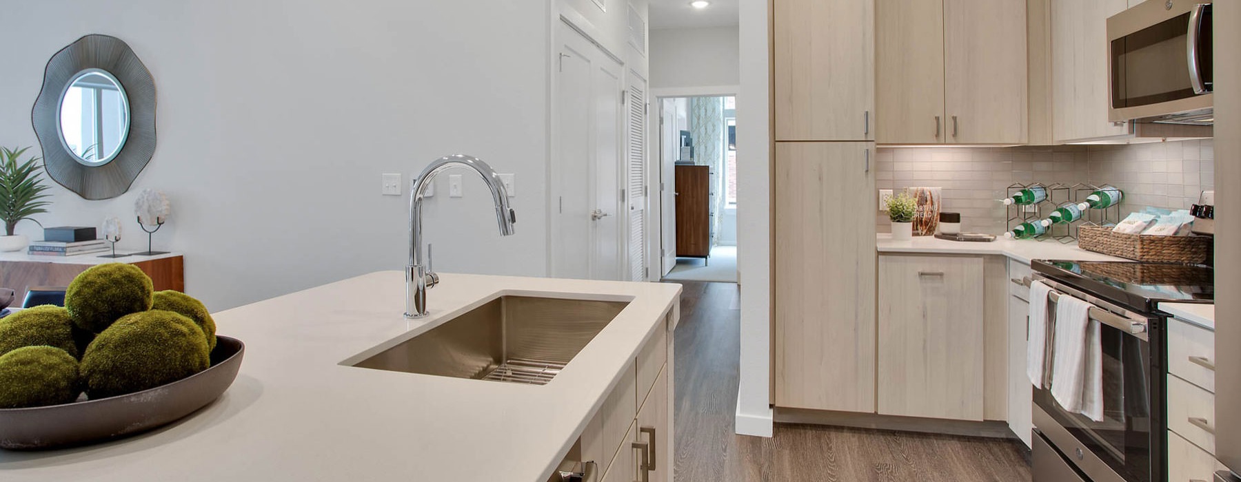 Modern kitchen with bright neutrals and wood-like flooring