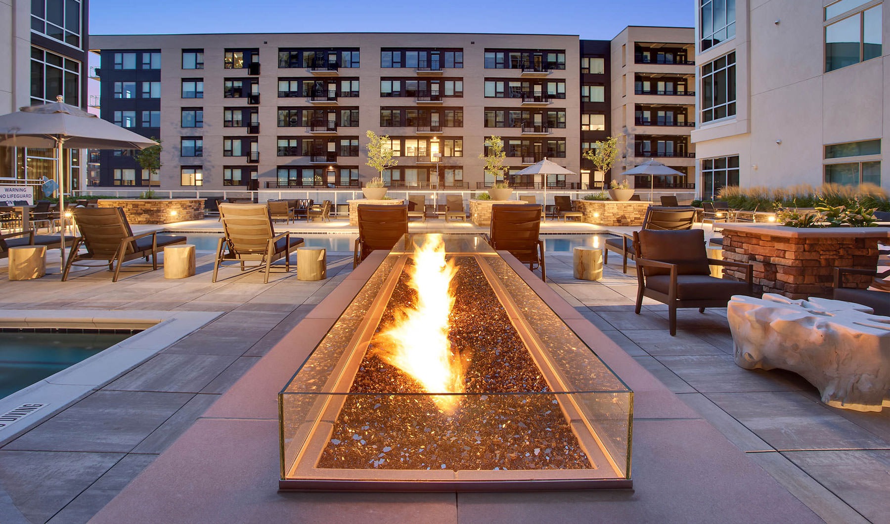 Outdoor fire pit and sparkling swimming pool