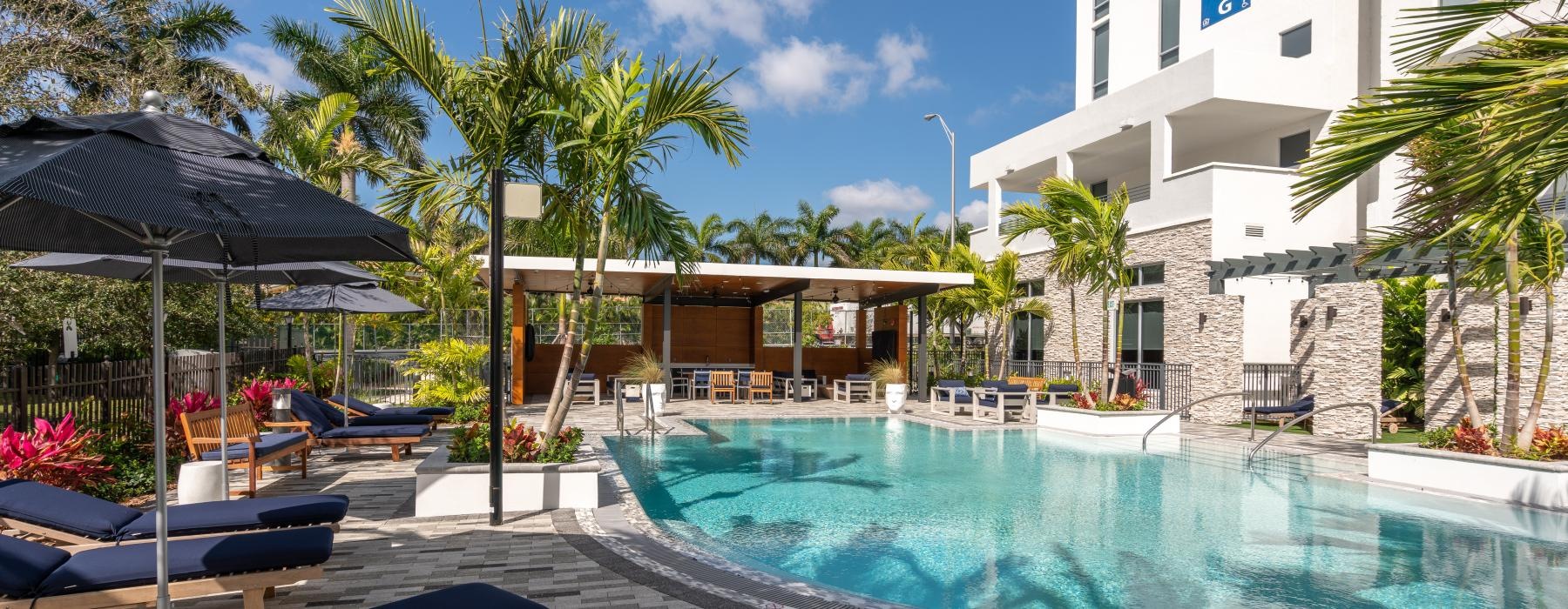 Large sparkling pool with large pool deck and lounge chairs