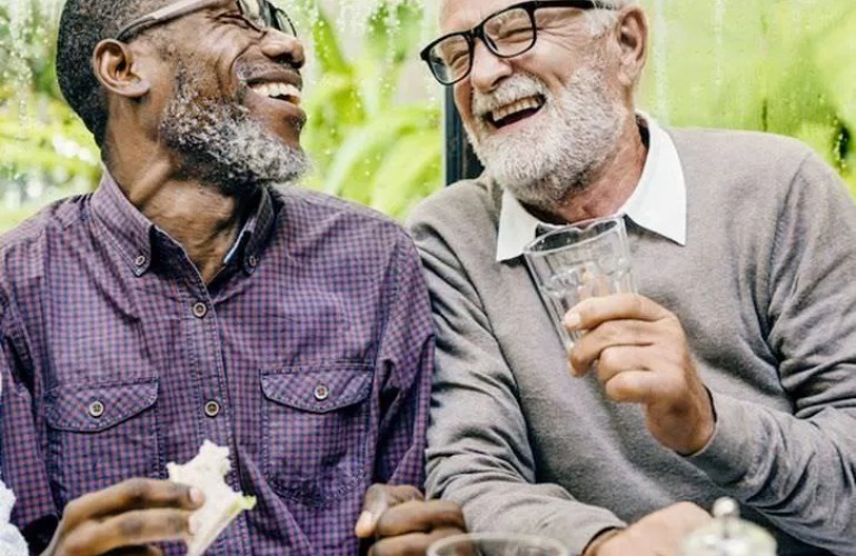 Two adult senior men talking and laughing.