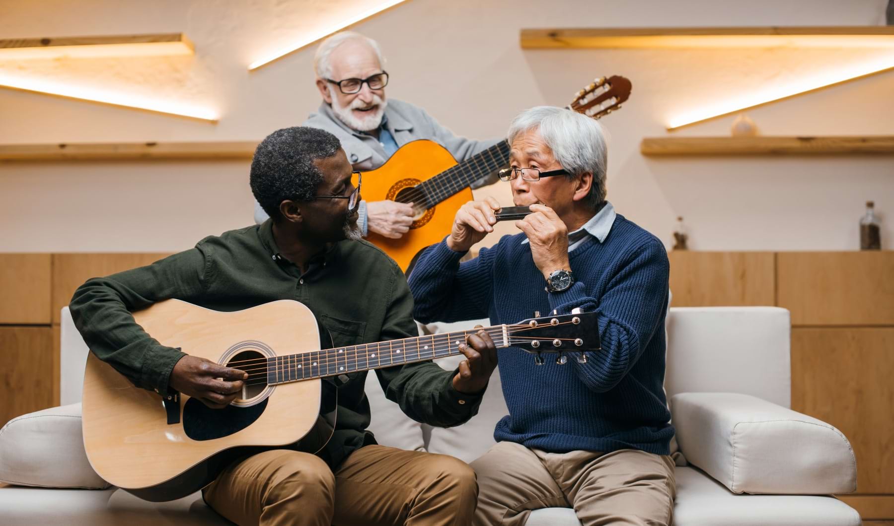 three men playing guitars
