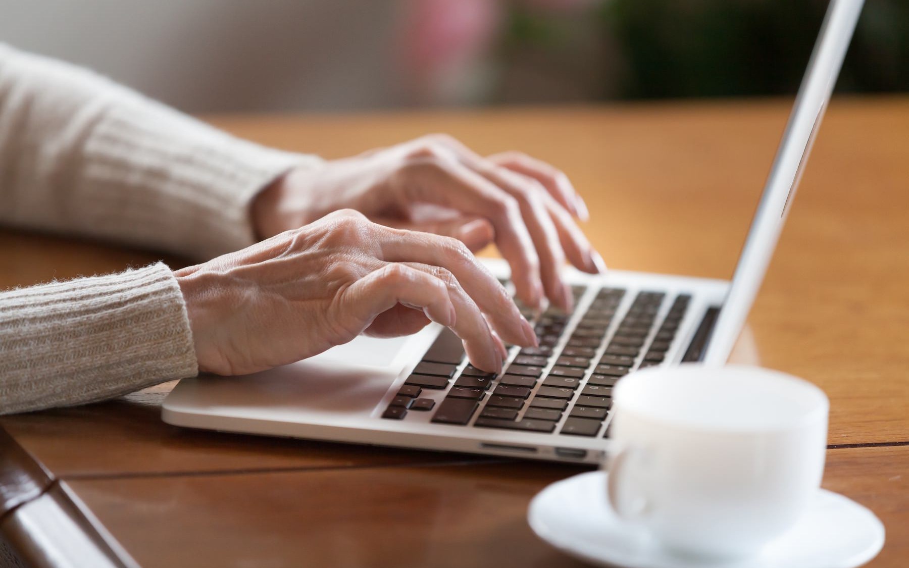 A person typing a a laptop