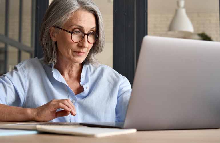 a person looking at a laptop