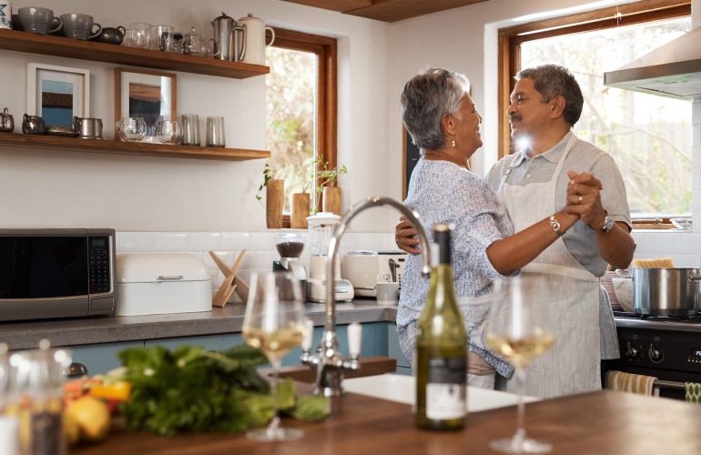 a couple dancing in a kitchen