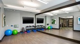 Yoga Studio with large mirror and wood floors