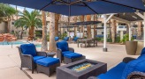 a fire pit surrounded by blue chairs