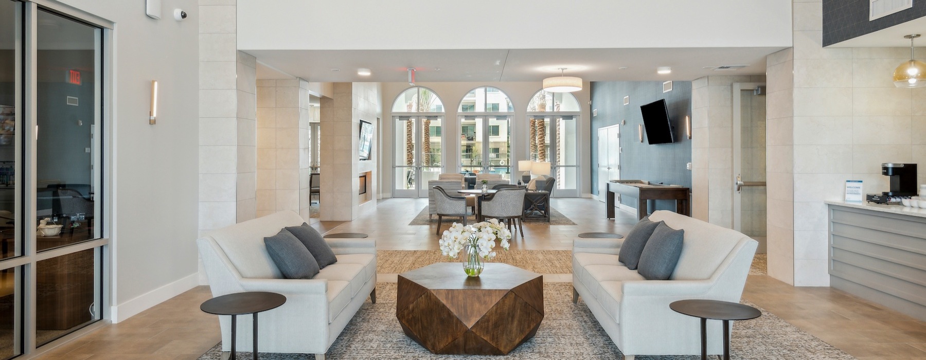 Resident lounge and lobby at Overture North Scottsdale senior community in Arizona, featuring couches and a coffee table. 